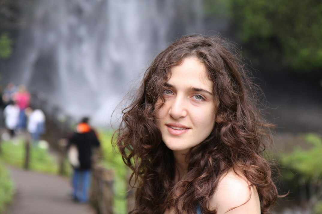 Portrait of a smiling young woman with curly hair