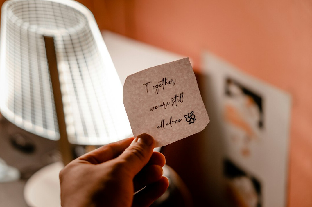 Person writing notes in a notebook at a desk